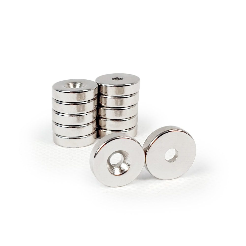Round Circular Disc Neodymium magnet with countersunk hole for screwing and with dimensions 14mm x 3.6mm (3.5mm Hole), grade N42 , featuring a nickel-copper-nickel coating and an 3.52KG pull force, commonly used in DIY, crafts, furniture design, fixings, kitchen design, lock mechanisms and science experiments.