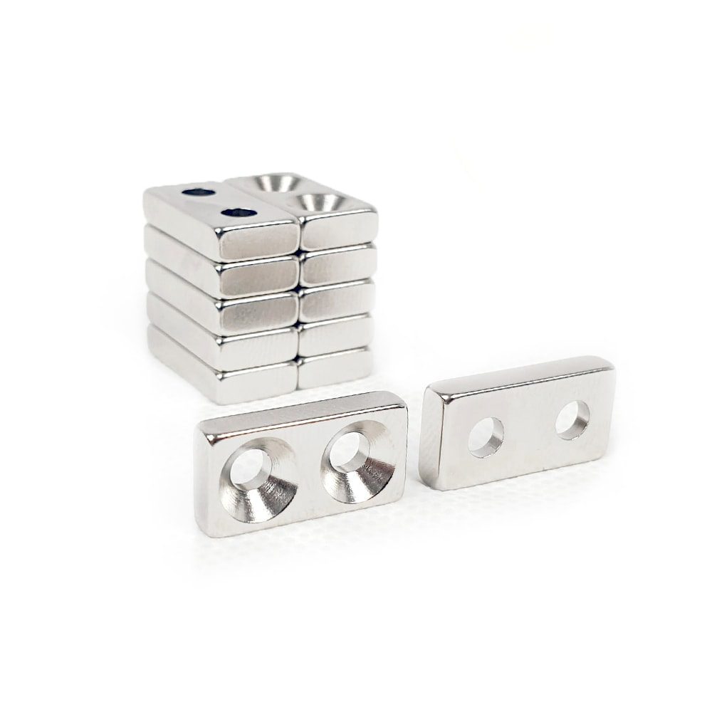 Rectangular Block Neodymium magnet with double countersunk hole for screwing and with dimensions 20mm x 10mm x 4mm (4mm Double Hole), grade N42, featuring a nickel-copper-nickel coating and an 2.81KG pull force, commonly used in DIY, crafts, furniture design, fixings, kitchen design, lock mechanisms and science experiments.