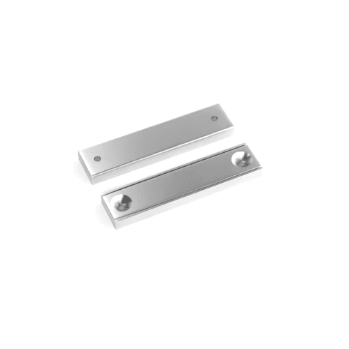 Rectangular block channel magnets with countersunk hole for screwing and with dimensions 50mm x 13.5mm x 5mm (Two 3.3mm c/s holes), grade N35 , featuring a nickel-copper-nickel coating and an 27KG pull force, commonly used for securing into a flat service and used as magnetic door latches or holding display items and signs into place.