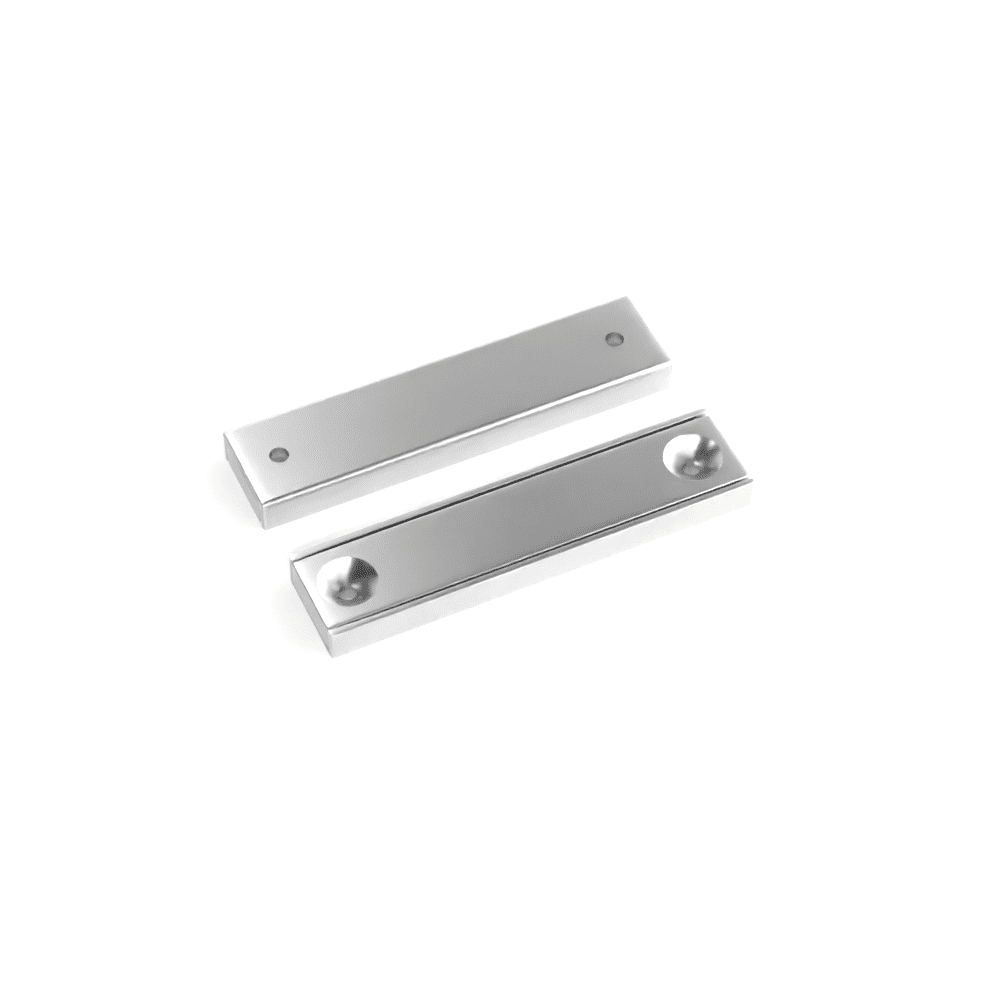Rectangular block channel magnets with countersunk hole for screwing and with dimensions 50mm x 13.5mm x 5mm (Two 3.3mm c/s holes), grade N35 , featuring a nickel-copper-nickel coating and an 27KG pull force, commonly used for securing into a flat service and used as magnetic door latches or holding display items and signs into place.