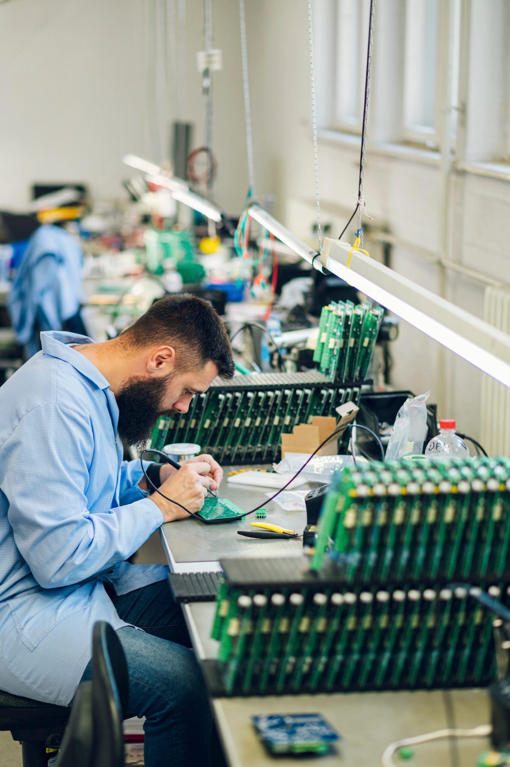 Electronics engineer working in a workshop with tin soldering pa